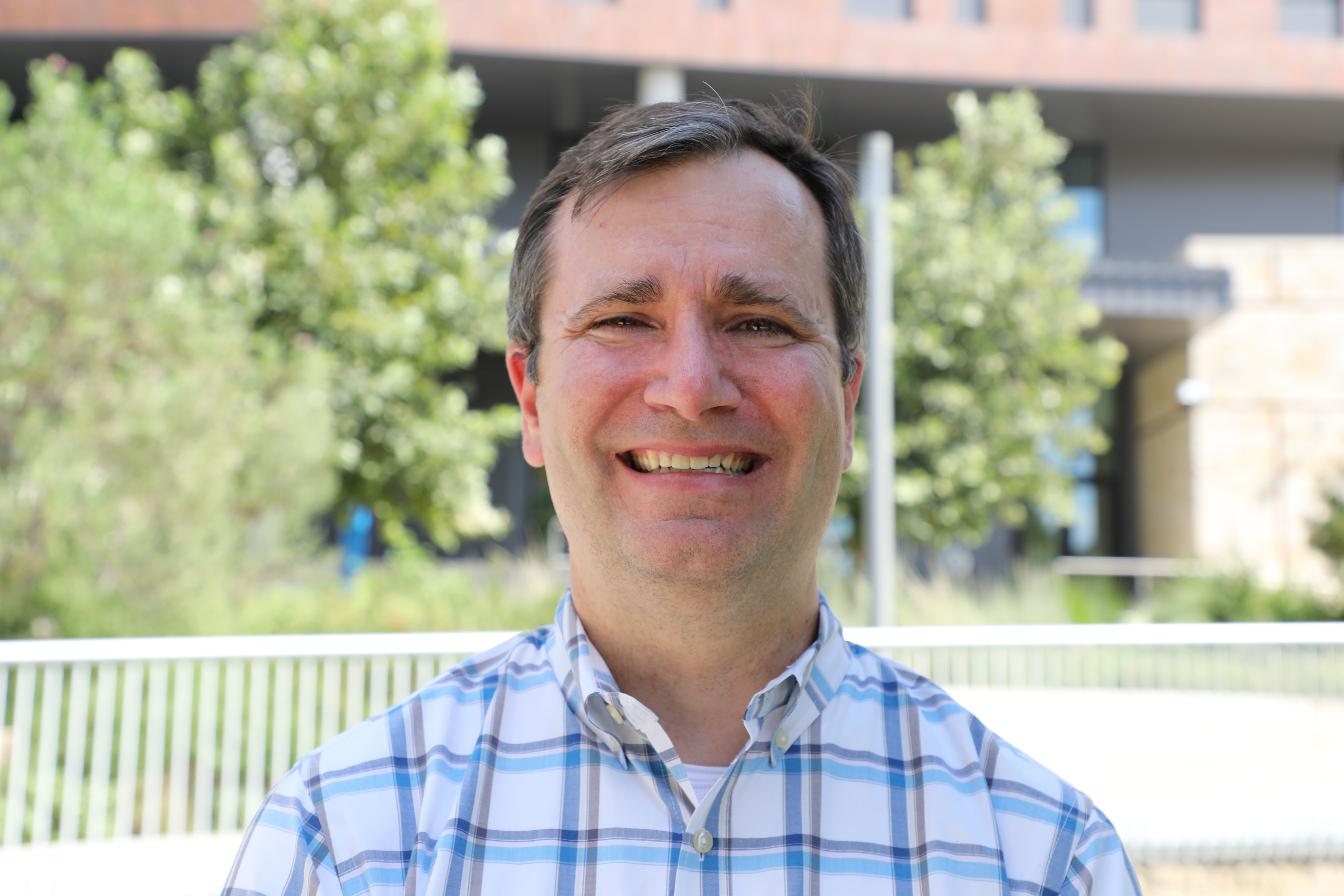 headshot of John Huggins